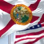 Florida state flag with American flag behind it